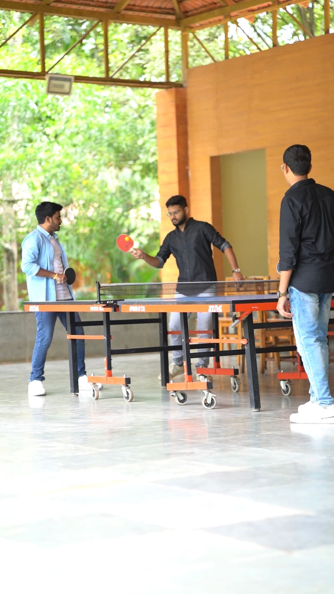 Table tennis in the games pavilion, mid-rally