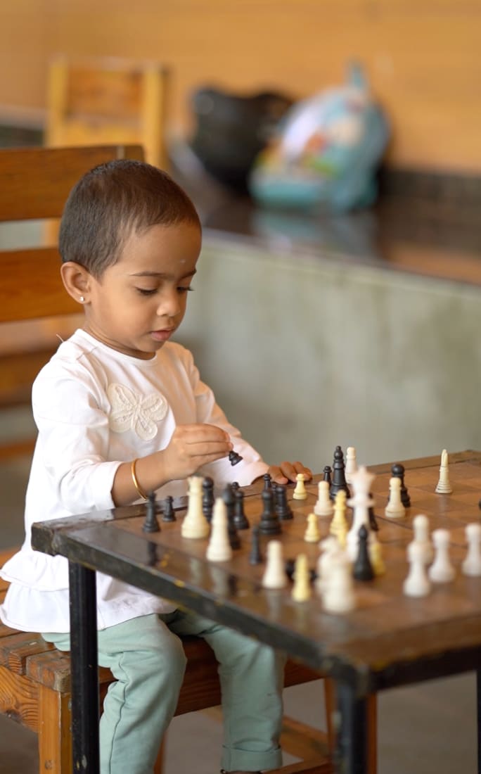 A young guest at the chess board in the games room