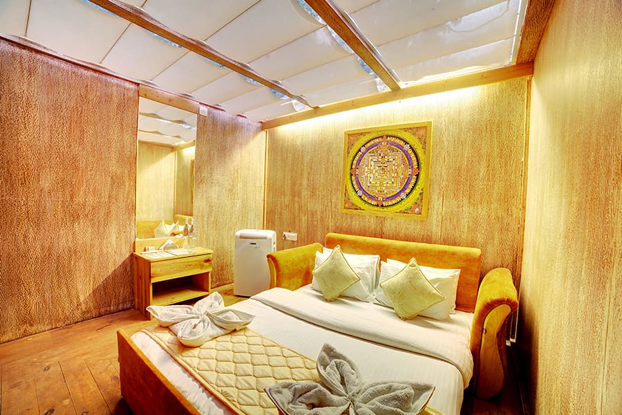 Inside the Camping Room, beds made up under the glass roof canopy