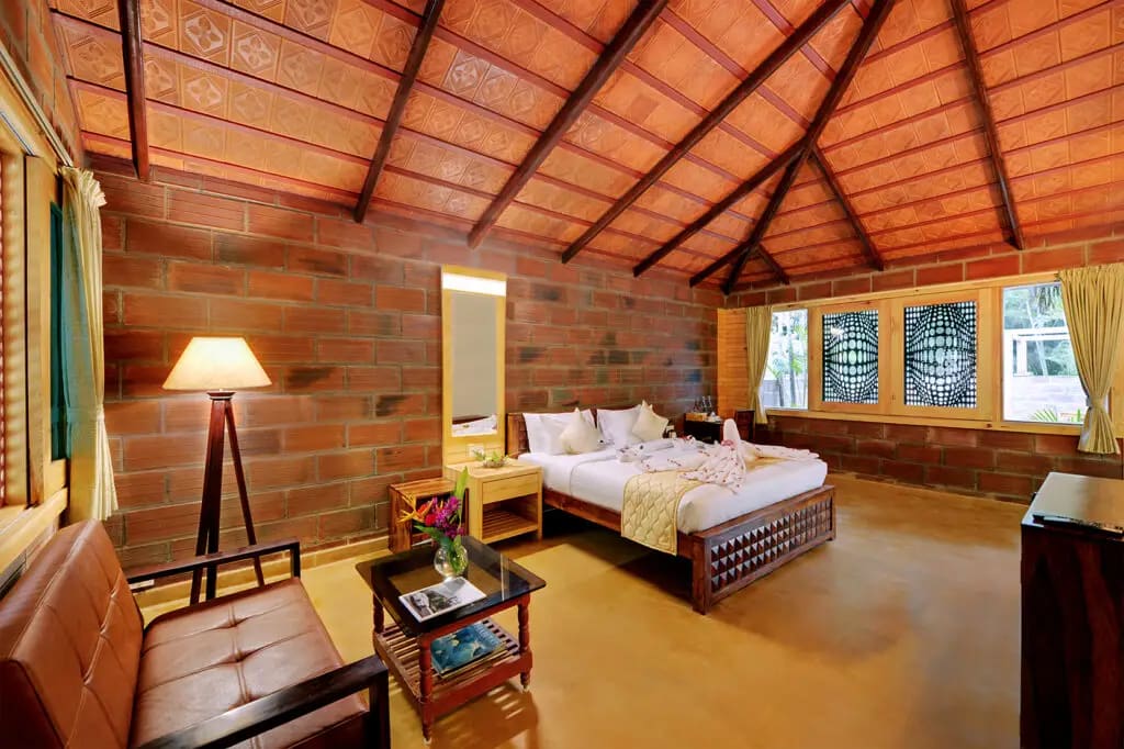 The Suite Room king bed with the sitting area visible in the same frame