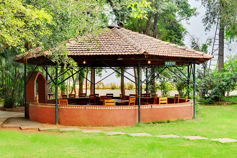 The patio lawn with its shaded pavilion, ready for a haldi or a small function